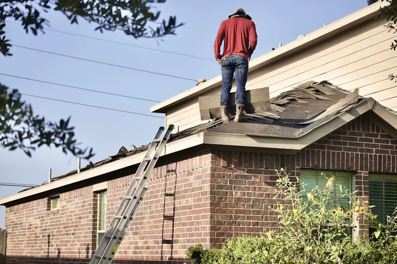 Professional roofer working on a residential roof in Fayburg